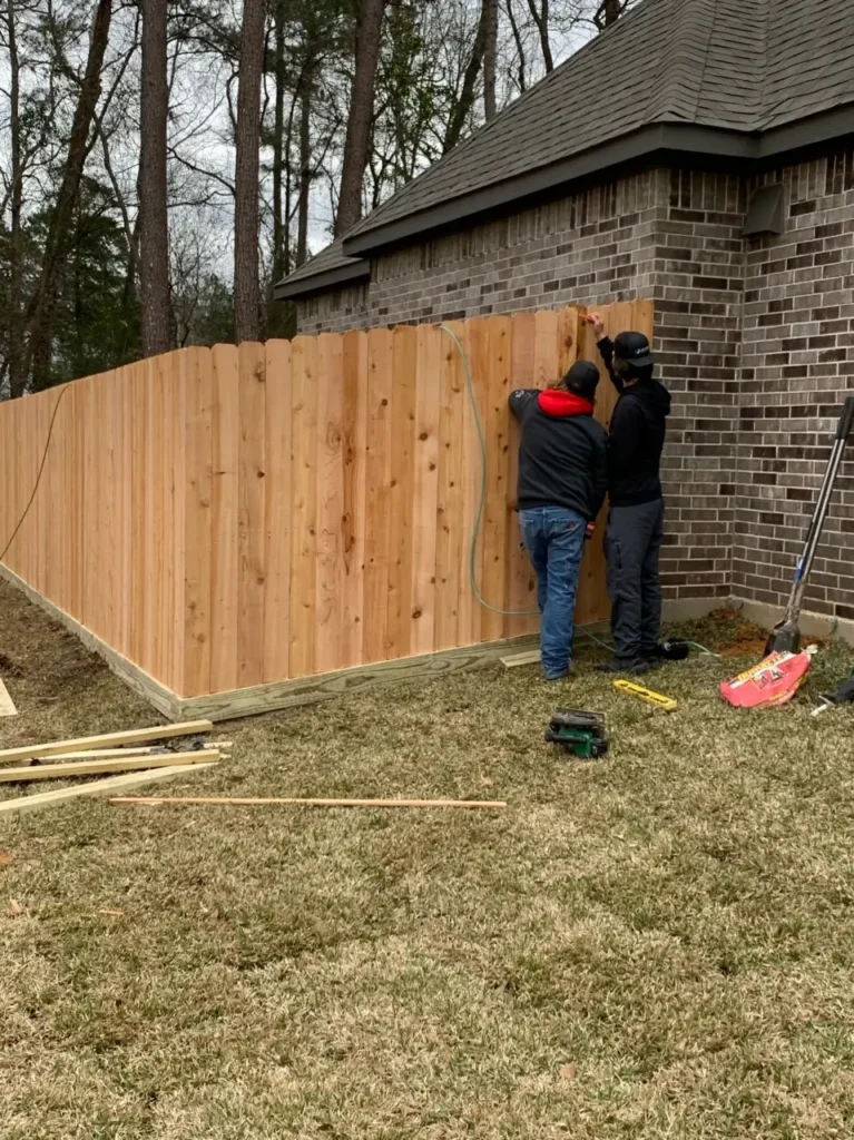 Builders Queenstown team installing wooden fencing for Fencing Queenstown.